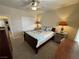 Bedroom with carpet, ceiling fan, closet, and a bed with floral bedding at 2300 S Washoe Ave, Pahrump, NV 89048