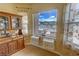 Bright dining area with scenic mountain views through a bay window and vintage china cabinet at 2300 S Washoe Ave, Pahrump, NV 89048