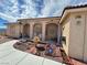 Home exterior with covered porch, decorative water fountain, and rock landscaping at 2300 S Washoe Ave, Pahrump, NV 89048
