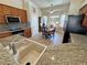 Well-lit kitchen featuring granite countertops, wooden cabinetry, a stainless steel refrigerator, and a dining area with mountain views at 2300 S Washoe Ave, Pahrump, NV 89048