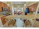 Spacious kitchen featuring granite countertops, wooden cabinets, stainless steel appliances, and a breakfast bar at 2300 S Washoe Ave, Pahrump, NV 89048