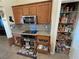 Kitchen with granite countertops, oak cabinets, stainless steel appliances and large pantry with storage at 2300 S Washoe Ave, Pahrump, NV 89048