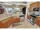 Bright kitchen with stainless steel appliances, granite counters, tile backsplash, and open floor plan to living area at 2300 S Washoe Ave, Pahrump, NV 89048