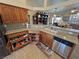 Open kitchen with granite countertops, oak cabinets, stainless steel appliances, open drawer storage and sink at 2300 S Washoe Ave, Pahrump, NV 89048