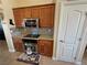 Kitchen with oak cabinetry, granite countertops, stainless steel appliances, and access to a doorway at 2300 S Washoe Ave, Pahrump, NV 89048