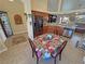 Kitchen and dining area with stainless steel refrigerator, tile flooring, and an open layout at 2300 S Washoe Ave, Pahrump, NV 89048