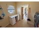 Laundry room with desk, window, and tile flooring at 2300 S Washoe Ave, Pahrump, NV 89048