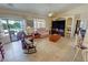 Open-concept living room with tile flooring, ceiling fan and view of backyard pool at 2300 S Washoe Ave, Pahrump, NV 89048
