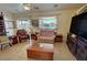 Cozy living room featuring tile floors, natural light, and comfortable seating at 2300 S Washoe Ave, Pahrump, NV 89048