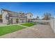 Expansive backyard with a modern home featuring a second-story balcony and spiral staircase overlooking the landscaped yard at 2521 Richfield Blvd, Las Vegas, NV 89102