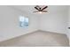 Empty bedroom with neutral carpet, a ceiling fan, and a window that provides natural light at 2521 Richfield Blvd, Las Vegas, NV 89102