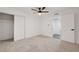 Spacious bedroom featuring neutral carpet, ceiling fan, and a walk-in closet at 2521 Richfield Blvd, Las Vegas, NV 89102