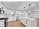 This bright kitchen features white cabinets, stainless appliances, and a large waterfall island with counter seating at 2521 Richfield Blvd, Las Vegas, NV 89102