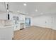 Open kitchen with stainless steel appliances, white cabinetry, tile backsplash, and a sliding glass door to the backyard at 2521 Richfield Blvd, Las Vegas, NV 89102