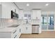 Kitchen features stainless steel appliances, white cabinets, and tile backsplash at 2521 Richfield Blvd, Las Vegas, NV 89102