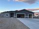 A single-story house with a three-car garage and a long driveway, offering ample parking and curb appeal at 2530 S Tecumseh Ave, Pahrump, NV 89048