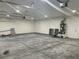 Well-lit garage with ample space featuring concrete floors at 2530 S Tecumseh Ave, Pahrump, NV 89048