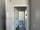 The hallway boasts neutral paint, white trim, and offers access to bedrooms, bathrooms, and other living spaces at 2530 S Tecumseh Ave, Pahrump, NV 89048