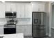 The modern kitchen features stainless steel appliances, white cabinets, and beautiful countertops, perfect for cooking enthusiasts at 2530 S Tecumseh Ave, Pahrump, NV 89048