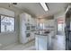 Bright kitchen featuring white cabinets, an island, and double ovens at 2714 Bridgepointe Dr, Las Vegas, NV 89121