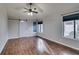 Living Room features wood floors, a barn door, multiple windows, and a ceiling fan at 2714 Bridgepointe Dr, Las Vegas, NV 89121