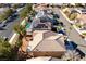 Aerial shot of neighborhood with a swimming pool, solar panels, tile roofs, and desert landscaping at 2743 Carolina Blue Ave, Henderson, NV 89052