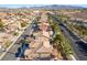 An aerial view of a suburban neighborhood featuring many tile roofs and desert landscaping at 2743 Carolina Blue Ave, Henderson, NV 89052