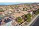 An elevated view of a neighborhood featuring a beige home with well-kept landscaping and mature trees at 2743 Carolina Blue Ave, Henderson, NV 89052