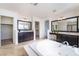Spacious bathroom with dual vanities, dark wood cabinets, a large tub, and walk-in closets on each side at 2743 Carolina Blue Ave, Henderson, NV 89052