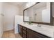 Modern bathroom with dual sinks, dark wood cabinets, and a large mirror at 2743 Carolina Blue Ave, Henderson, NV 89052