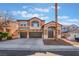 Two-story home with a well-manicured lawn and a two-car garage in a residential area at 2743 Carolina Blue Ave, Henderson, NV 89052