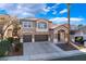 Inviting two-story home with a three-car garage, beautiful architectural details, and an ample driveway at 2743 Carolina Blue Ave, Henderson, NV 89052