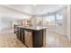 Kitchen island with stainless steel dishwasher, stone countertop, and lots of natural light at 2743 Carolina Blue Ave, Henderson, NV 89052