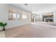 Bright living room with large windows, sliding glass doors, and an open layout connecting to the kitchen at 2743 Carolina Blue Ave, Henderson, NV 89052