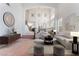 Bright, airy living room with high ceilings, featuring neutral decor, comfortable seating, and an open staircase at 2743 Carolina Blue Ave, Henderson, NV 89052