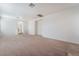 Expansive living room featuring neutral carpet, a large closet, and an arched hallway leading to a bathroom at 2743 Carolina Blue Ave, Henderson, NV 89052