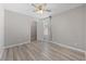 Bright bedroom features wood-look floors, ceiling fan, window, and a walk-in closet at 2785 Donatello Manor Pl, Henderson, NV 89044