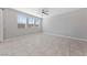 A bright bedroom has a ceiling fan, tiled floor and three large windows at 2785 Donatello Manor Pl, Henderson, NV 89044
