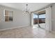 Dining area with modern light fixture, large windows, and sliding glass door at 2785 Donatello Manor Pl, Henderson, NV 89044