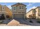 Two-story home featuring a front-facing two-car garage and a brick paver driveway at 2785 Donatello Manor Pl, Henderson, NV 89044