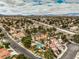 High aerial showcases a well-planned community, mature greenery, and swimming pools at 2812 Mirage Rd, Henderson, NV 89074