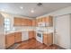 Efficient kitchen featuring white appliances and wood cabinets, offering ample storage at 2812 Mirage Rd, Henderson, NV 89074