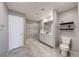 Bright bathroom with a glass-enclosed shower, double sink vanity, tile flooring, and decorative shelving at 2844 Alenga St, Henderson, NV 89044