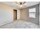 Neutral bedroom with a gray carpet, standard closet, and window overlooking rooftops at 2844 Alenga St, Henderson, NV 89044