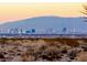Distant city skyline at sunset, silhouetted against a backdrop of desert terrain and mountains at 2844 Alenga St, Henderson, NV 89044