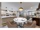 Dining area with contemporary lighting and view of the open kitchen at 2844 Alenga St, Henderson, NV 89044