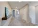 Neutral-toned hallway with carpet, display ledge, and doors to other rooms at 2844 Alenga St, Henderson, NV 89044
