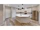 Modern kitchen featuring stainless steel appliances, a large island, and sleek white cabinets at 2844 Alenga St, Henderson, NV 89044