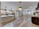 Bright, open-concept living room with hardwood floors and modern kitchen island perfect for entertaining and Gathering gatherings at 2844 Alenga St, Henderson, NV 89044