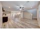 Open-concept living room featuring hardwood floors, neutral walls, and a seamless transition to the kitchen space at 2844 Alenga St, Henderson, NV 89044